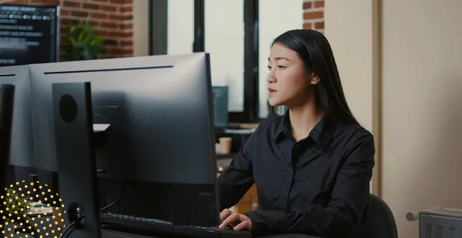 imagem de uma mulher sentada na frente de um computador