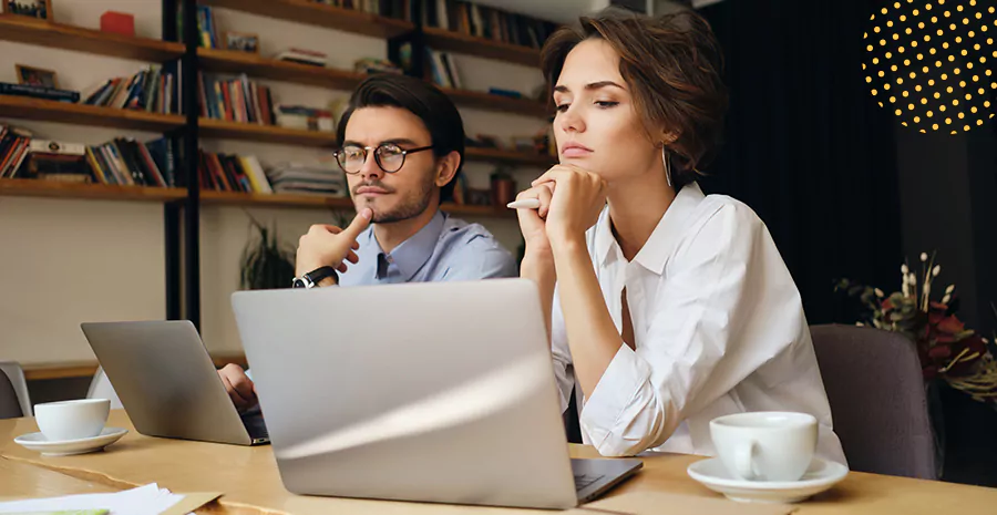 imagem de um homem e uma mulher sentados na frente de computadores