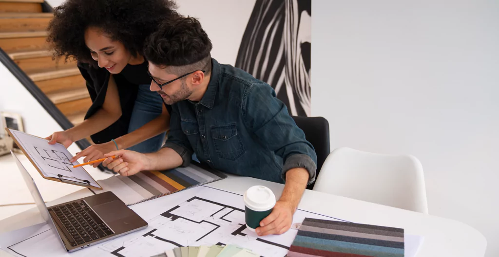 imagem mostra um homem e uma mulher analisando informações em um papel