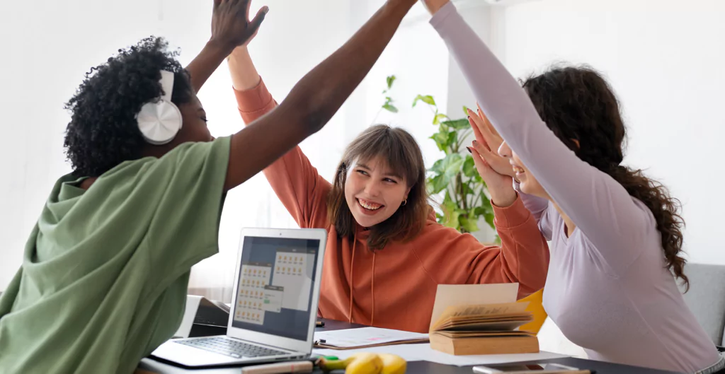 Equipe celebrando conquista, simbolizando sucesso e satisfação do cliente no customer success.
