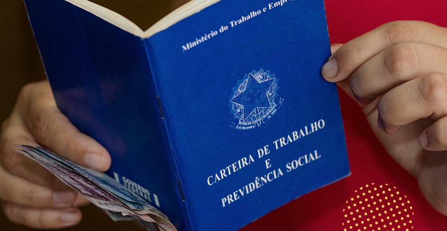 imagem de uma pessoa segurando a carteira de trabalho e previdência social junto com notas de dinheiro