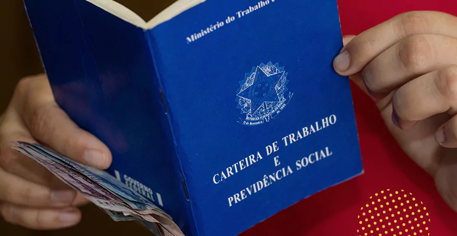 imagem de uma pessoa segurando a carteira de trabalho junto com notas de dinheiro