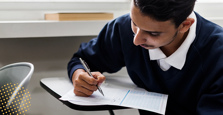 imagem de um homem sentado escrevendo em um caderno